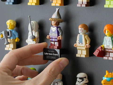 LEGO minifigure display tag being added to a wall case