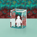 Acrylic display case with custom printed pixelated video game design that fits one minifigure