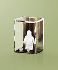 Acrylic display case with custom printed forest design that fits one minifigure