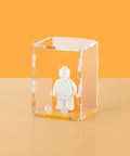 orange pastel colored acrylic display case for a single LEGO minifigure