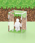 Pixel grass graphic printed onto the back of a clear acrylic display case for a single LEGO minifigure
